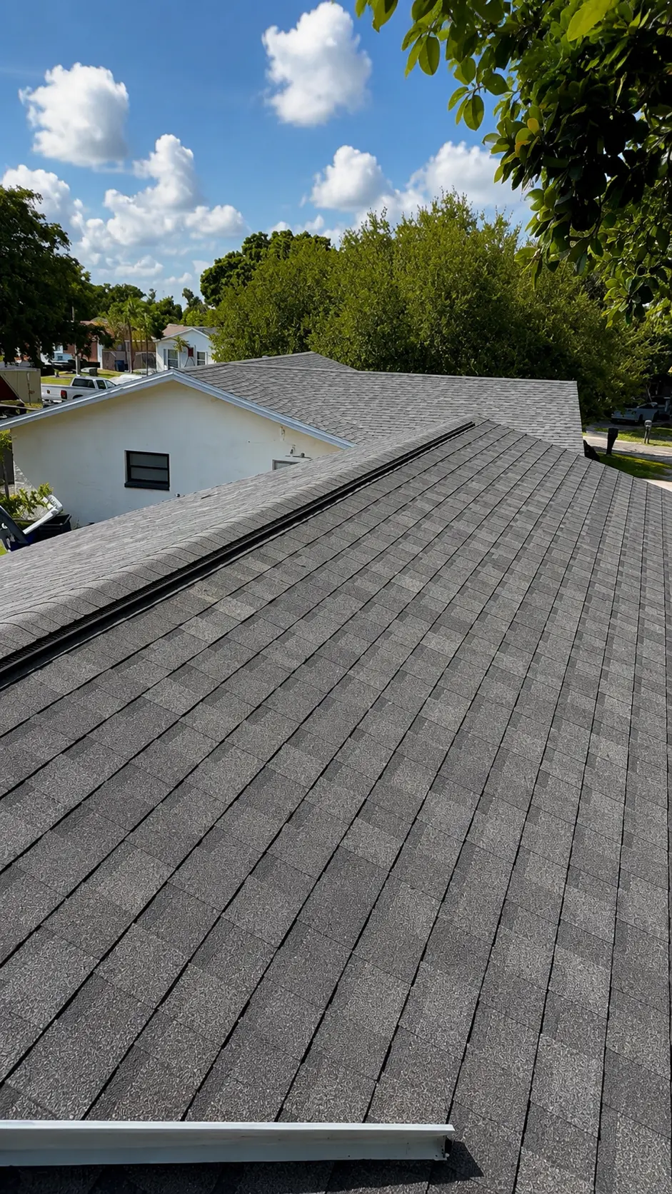 Completed architectural shingle roof with new ridge vent on a Florida home
